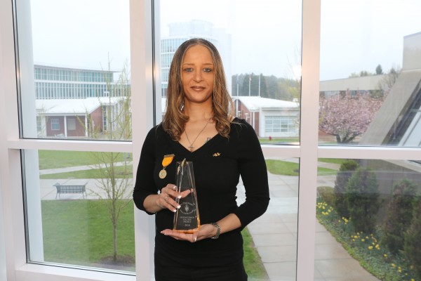 Margery Frost, MCC chapter president, shows off the Distinguished College Project Hallmark Award.